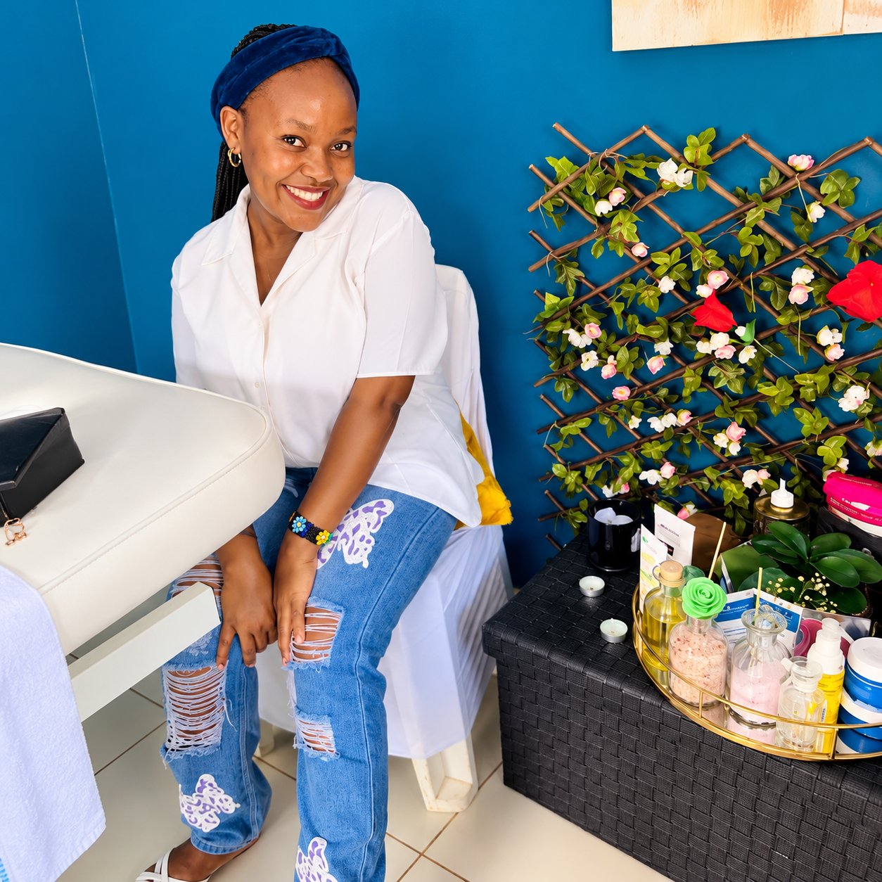 A guest beside a floral trellis in the spa