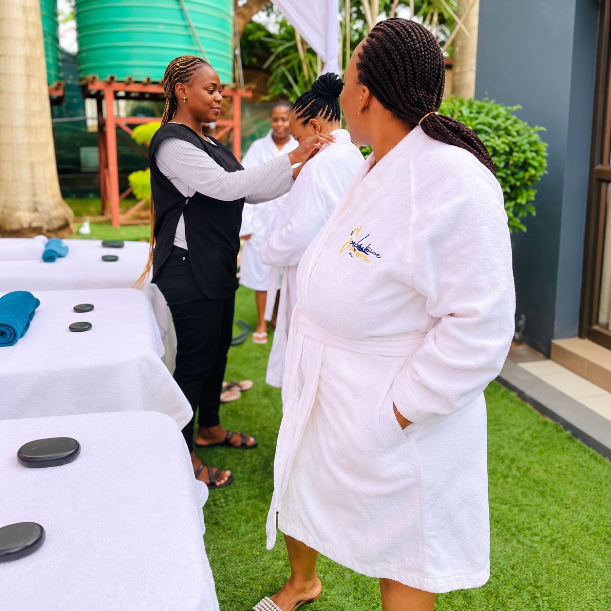 A guest and spa staff in the outdoor garden treatment area