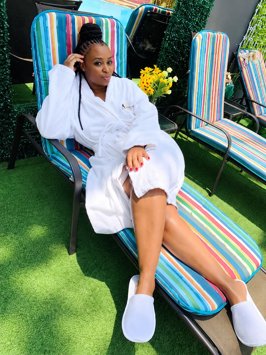 A guest unwinding in a colourful outdoor lounge chair